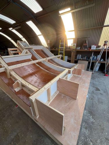 Curved concrete mould assembly in manufacturing workshop